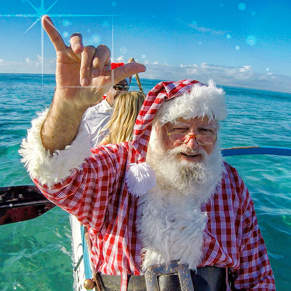 Santa shaka in canoe on water